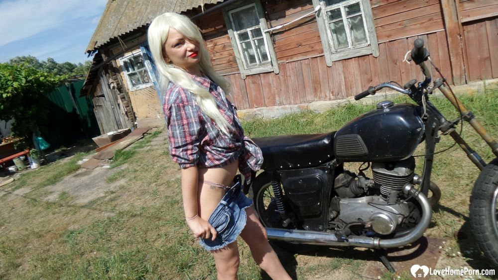 Blonde babe posing naked on a bike #11