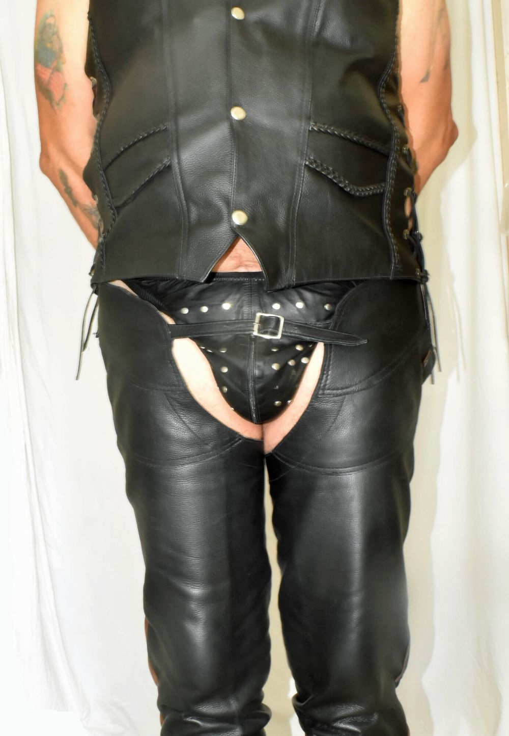 DRESSED IN A TIGHT SEXY LEATHER CHAPS AND JACKET VEST.. #16