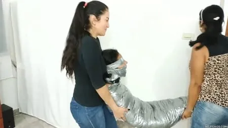 heavily duct tape mummified by crazy bondage women         