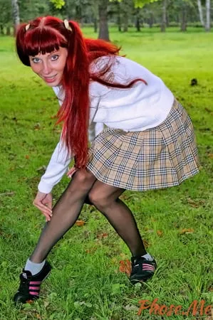 redhead outdoors in plaid skirt and black pantyhose         