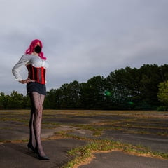 Fake tits crossdresser in short skirt and corset out side