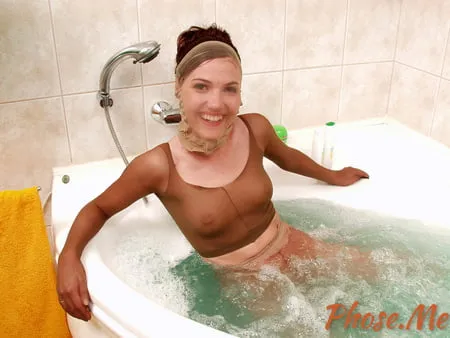 cute brunette in pantyhose encasement in the bathtub         