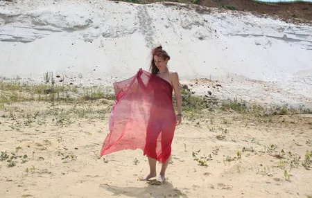 red shawl on white sand         