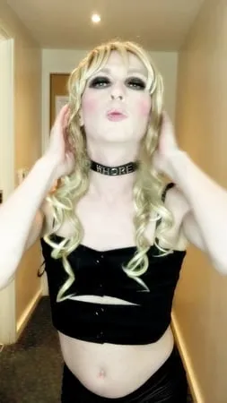 sissy crossdresser in black slut outfit posing         