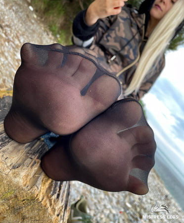 In dirty black nylon socks on the seashore