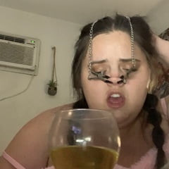 Fat piggy squats over wine glass