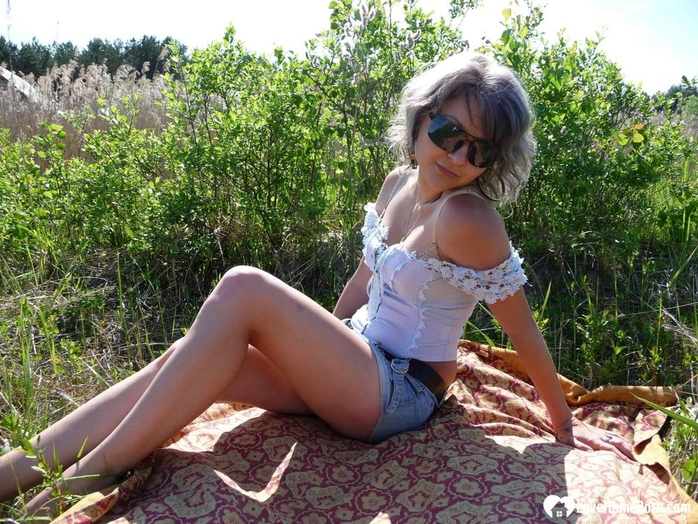 Gray-haired beauty posing naked outdoors on a blanket #4