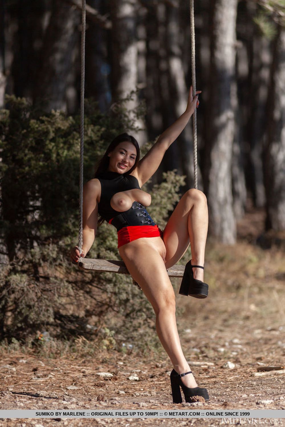 Sumiko playfully poses in a wooden swing #6