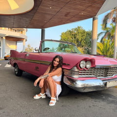 Monika Fox Posing Next To A Pink Plymouth