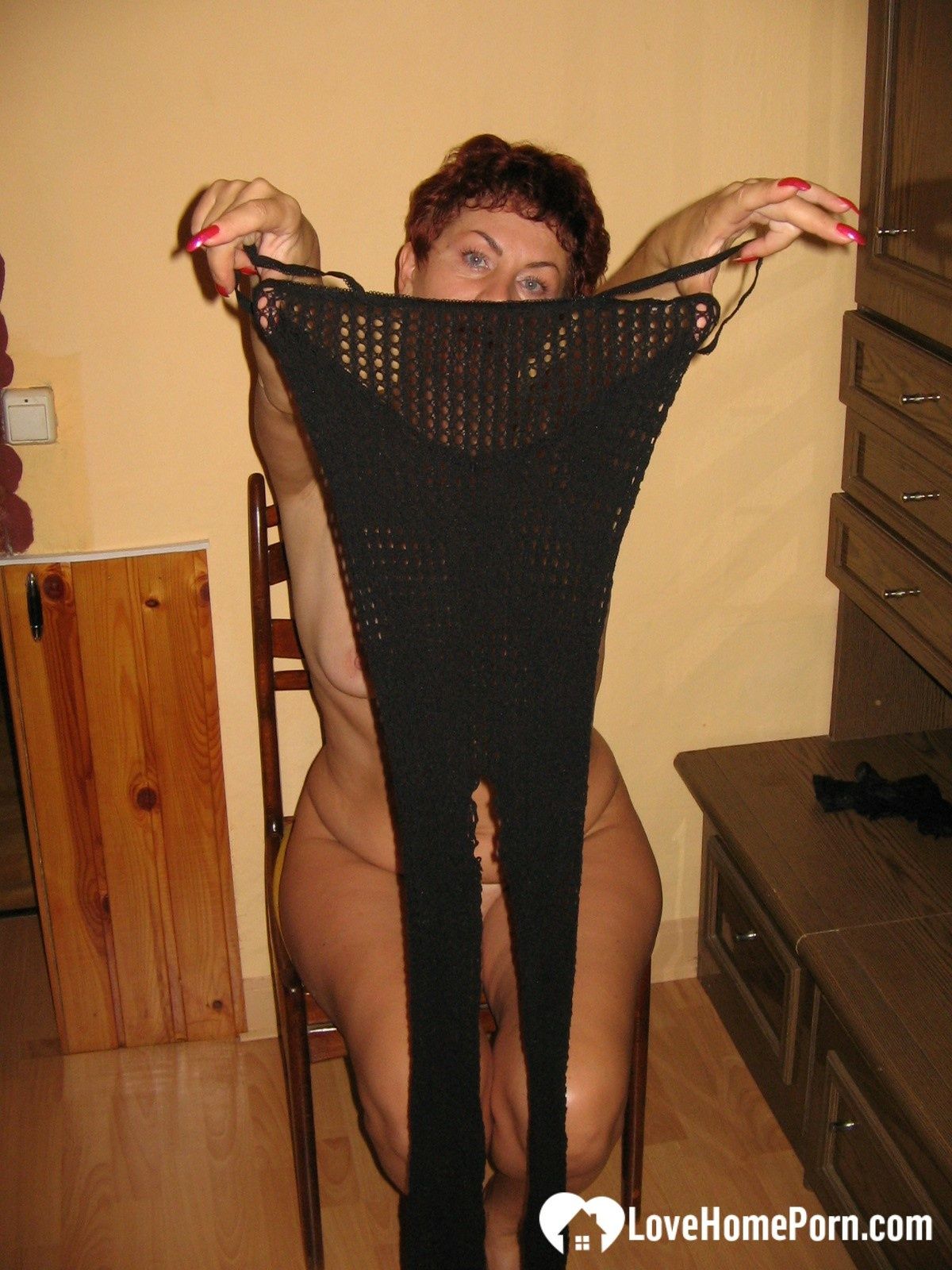 MILF in a fishnet masturbates with a whip #15