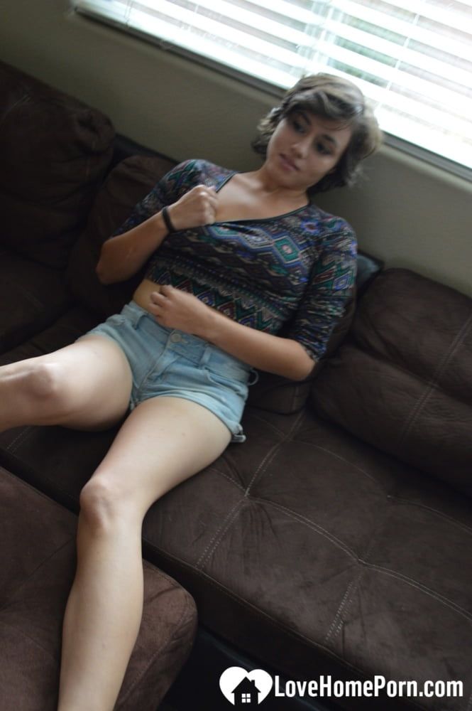 Pretty brunette satisfies herself on the couch #10