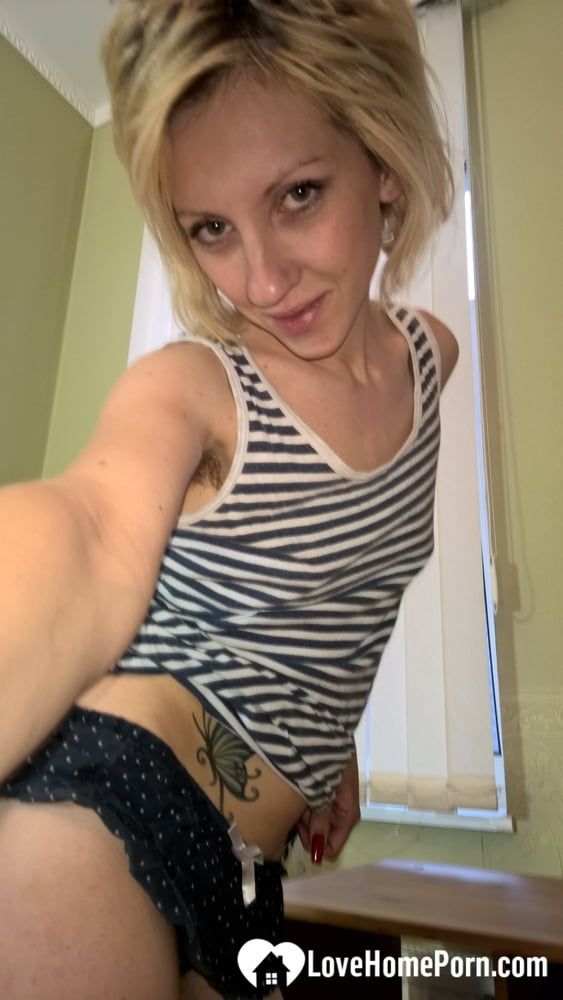 Cute blonde shows her tattoo and bush #3