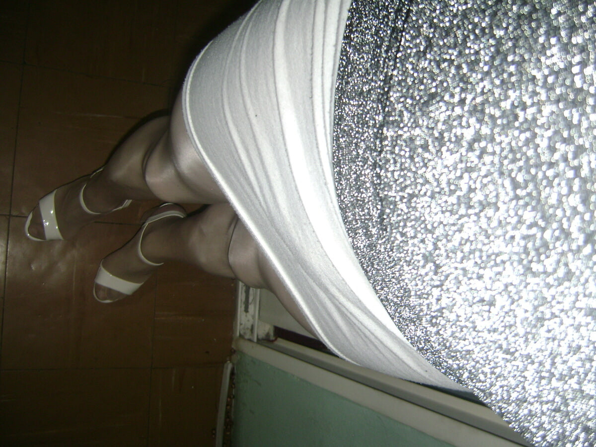 In a white miniskirt and some beautiful high heels