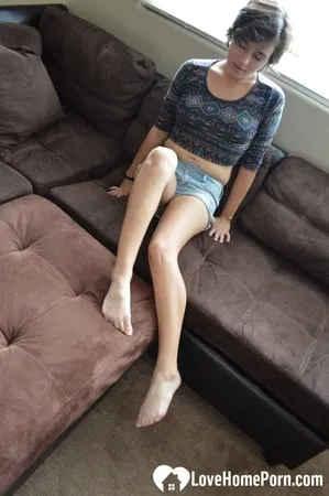 pretty brunette satisfies herself on the couch         