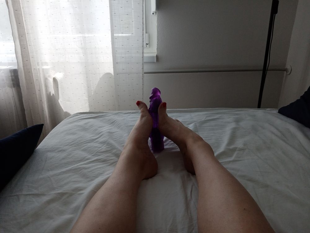 Tranny in a lying position simulates a Footjob with vibrator #4