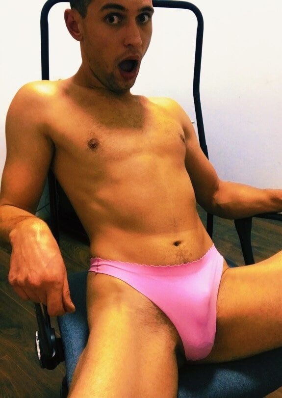 Twink boy poses in a pink thong 