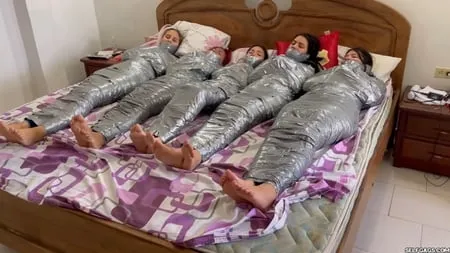   mummified girls barefoot in duct tape bondage         