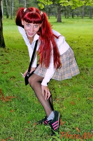 redhead outdoors in plaid skirt and black pantyhose         