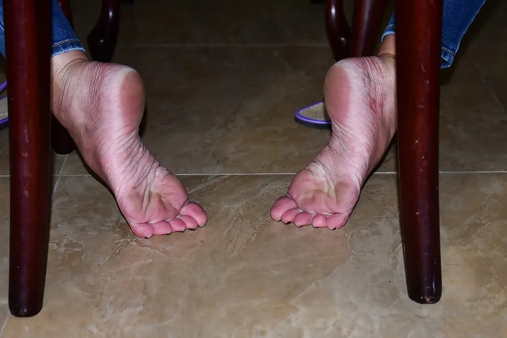 Dirty Bare Feet and Flip Flops Under the Chair #2