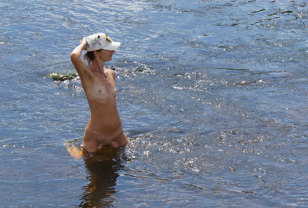 Nude in river's water