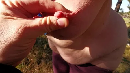 nipple stretching outdoors         