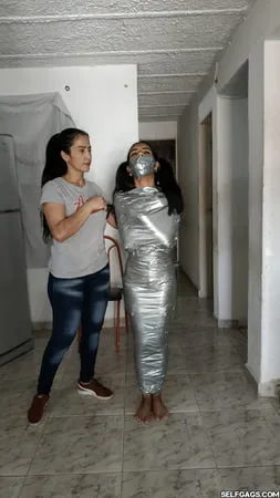 young girl duct tape wrapped like an egyptian mummy         