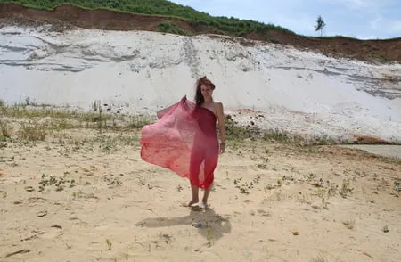 red shawl on white sand         