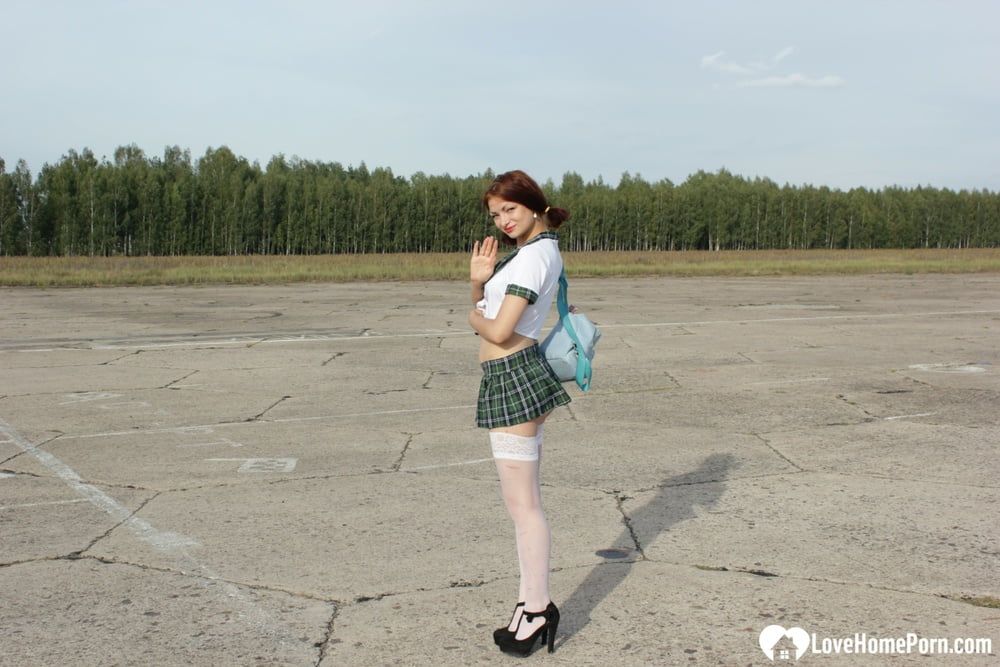 Incredible mom in a schoolgirl outfit posing outdoors #2