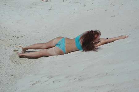 on white sand in turquos bikini         