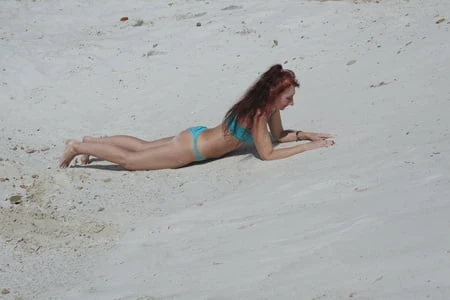 on white sand in turquos bikini         