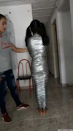 young girl duct tape wrapped like an egyptian mummy         