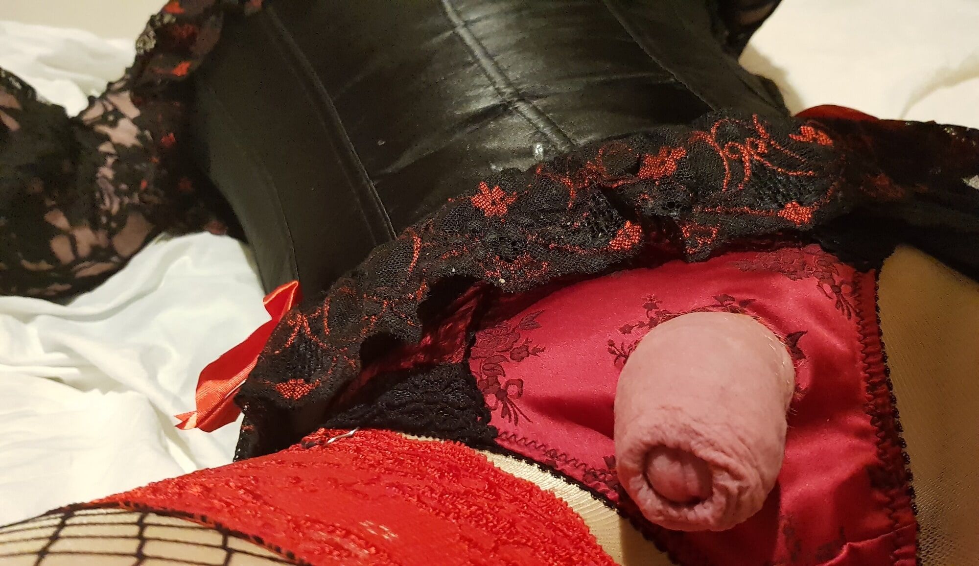 Crossdressing in black and red satin lingerie with fishnets #2