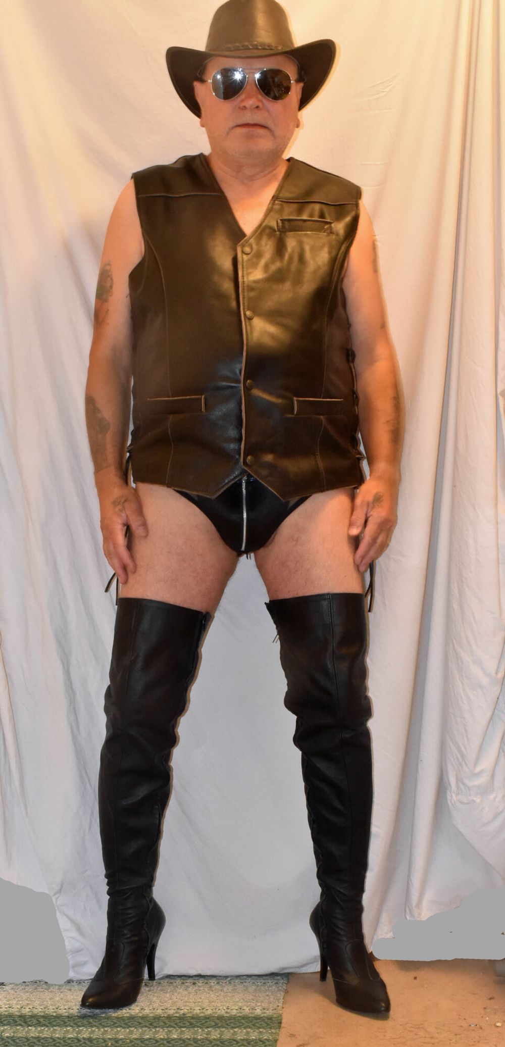 A TIGHT BLACK NYLON WITH A LEATHER AND COWBOY BOOTS. #9