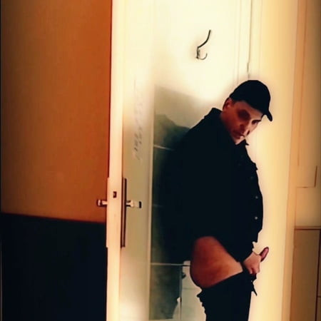 Handjob standing in front of a door