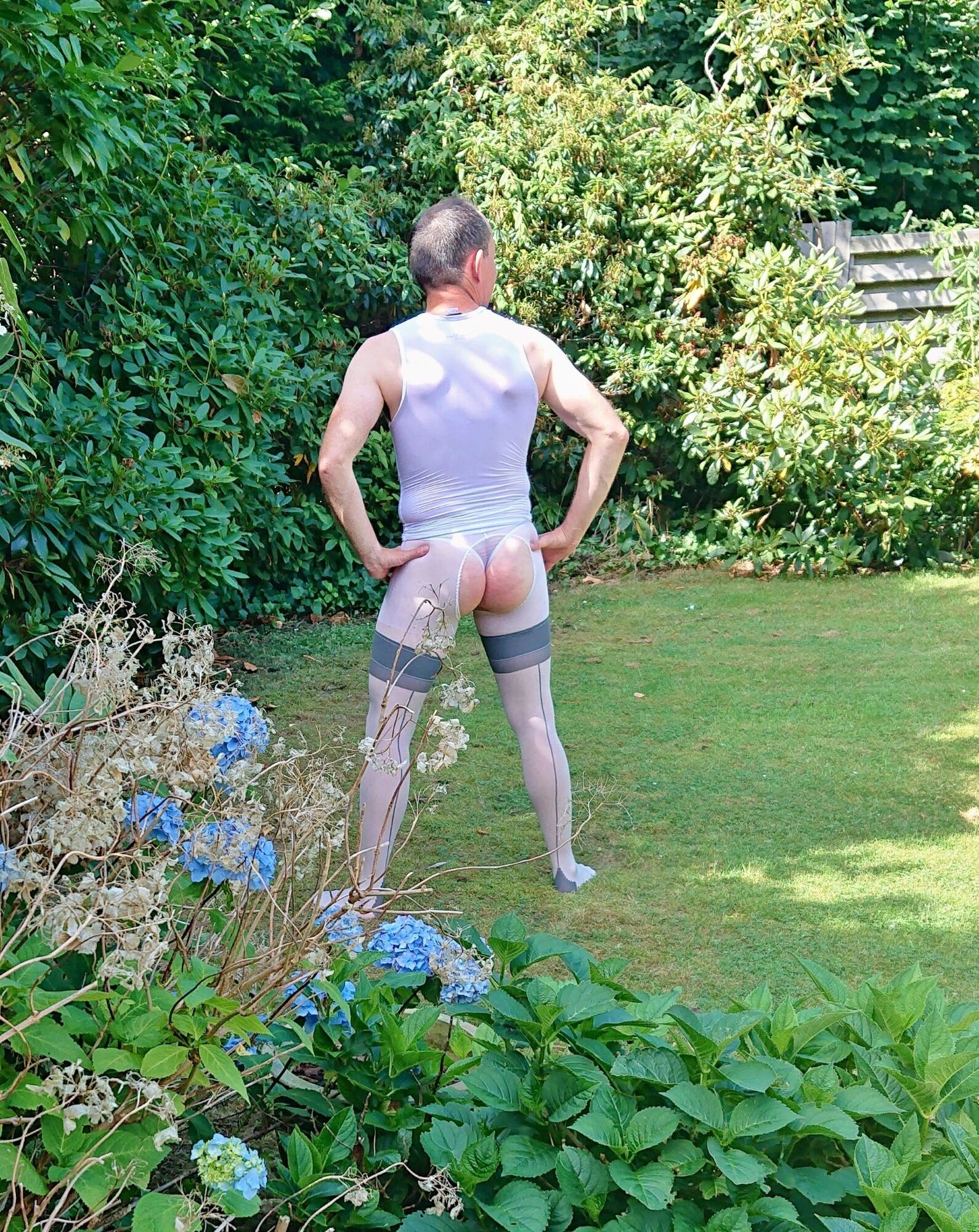 Posing in sexy nylon lingerie in a garden #11