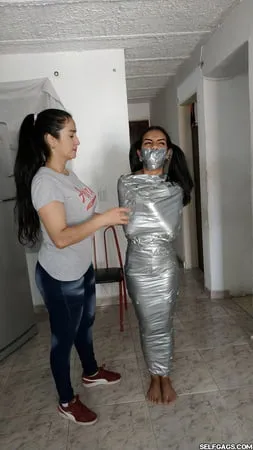 young girl duct tape wrapped like an egyptian mummy         