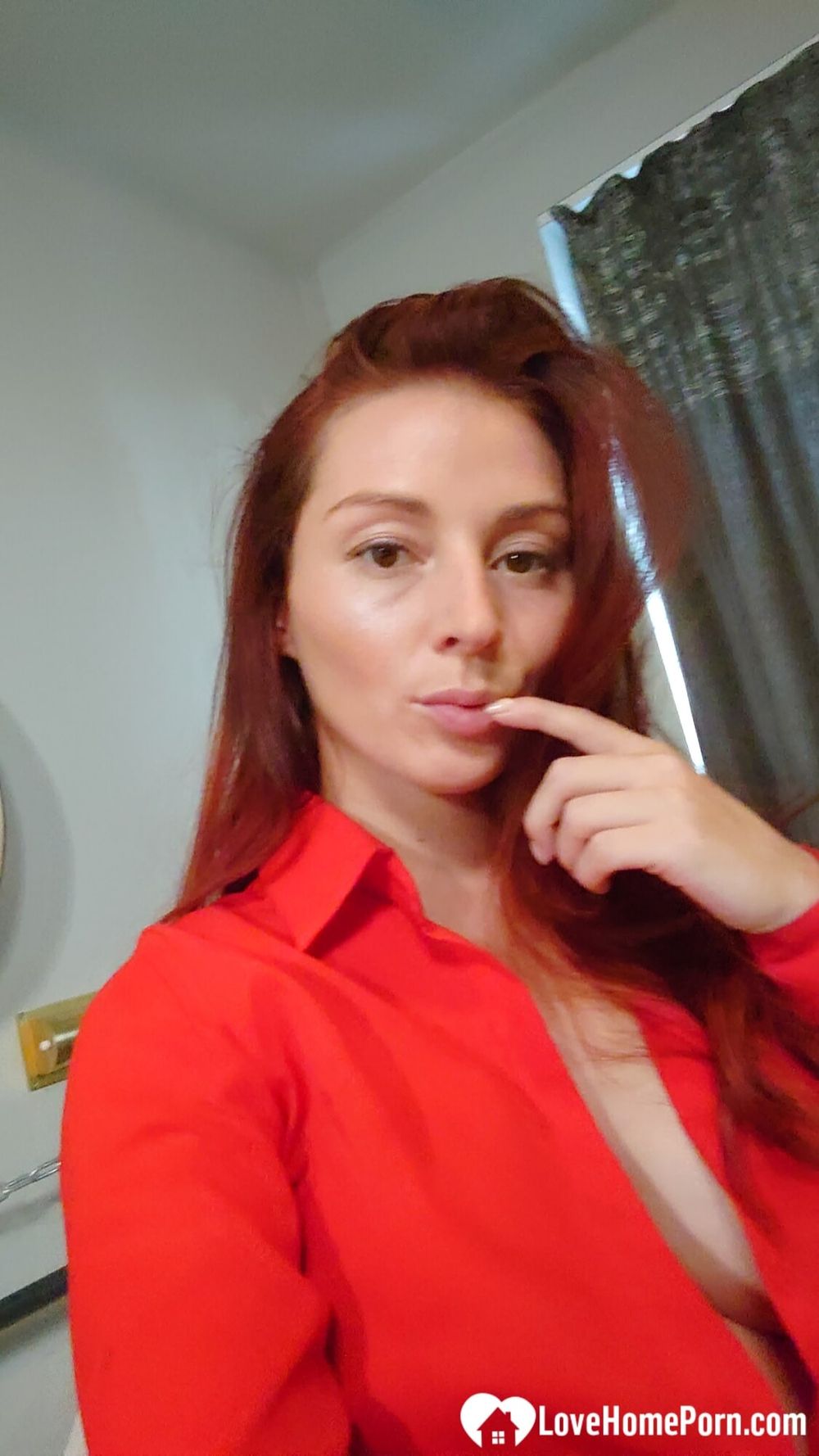 Naughty redhead reveals her big tits on cam #2