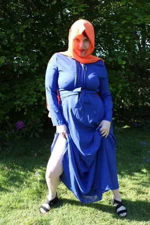 hijab and abaya flashing outdoors         