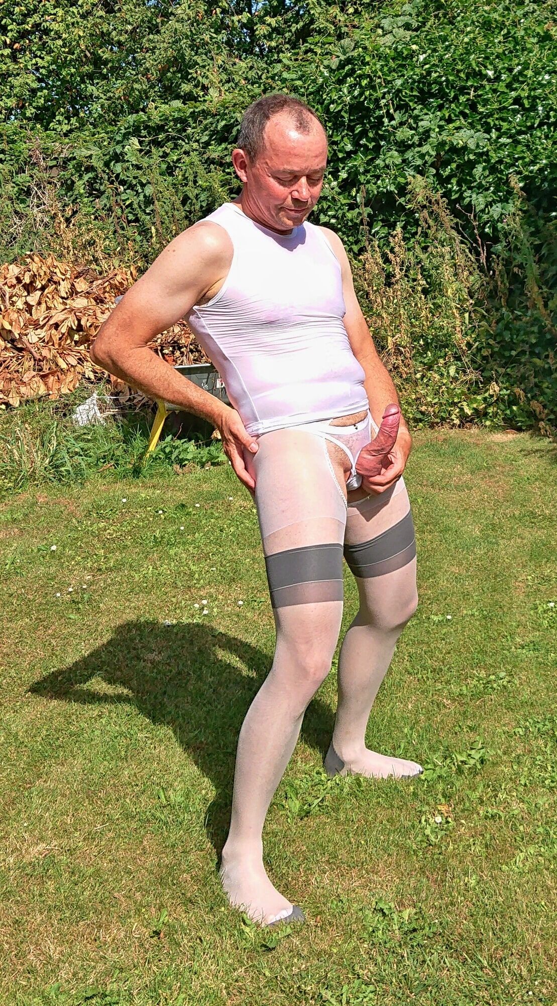 Posing in sexy nylon lingerie in a garden #23