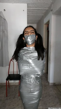 young girl duct tape wrapped like an egyptian mummy         