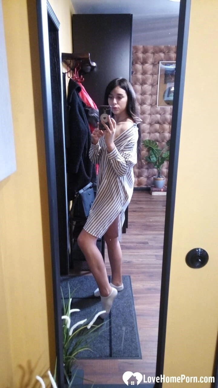 Cute long-haired brunette takes selfies in the bathroom  #8