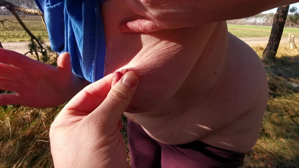 Nipple stretching outdoors