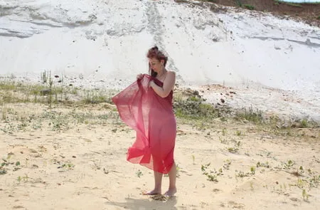 red shawl on white sand         