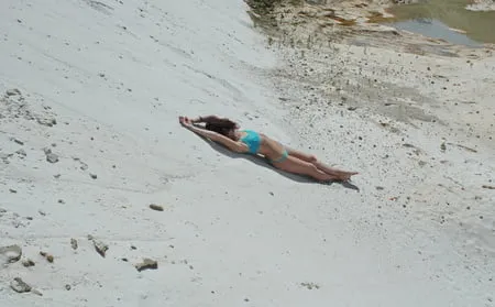 on white sand in turquos bikini         