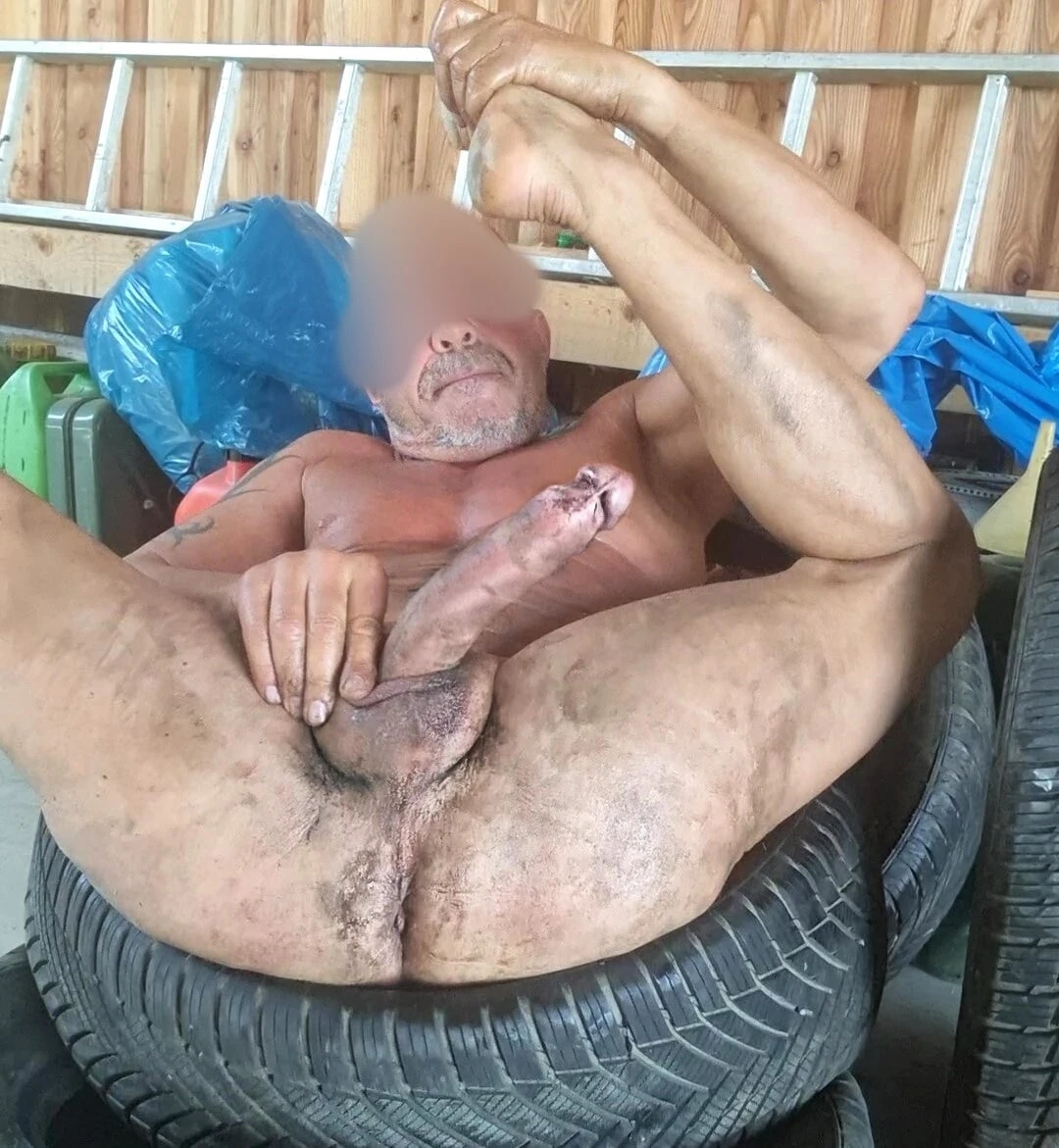 working nude in tire shop