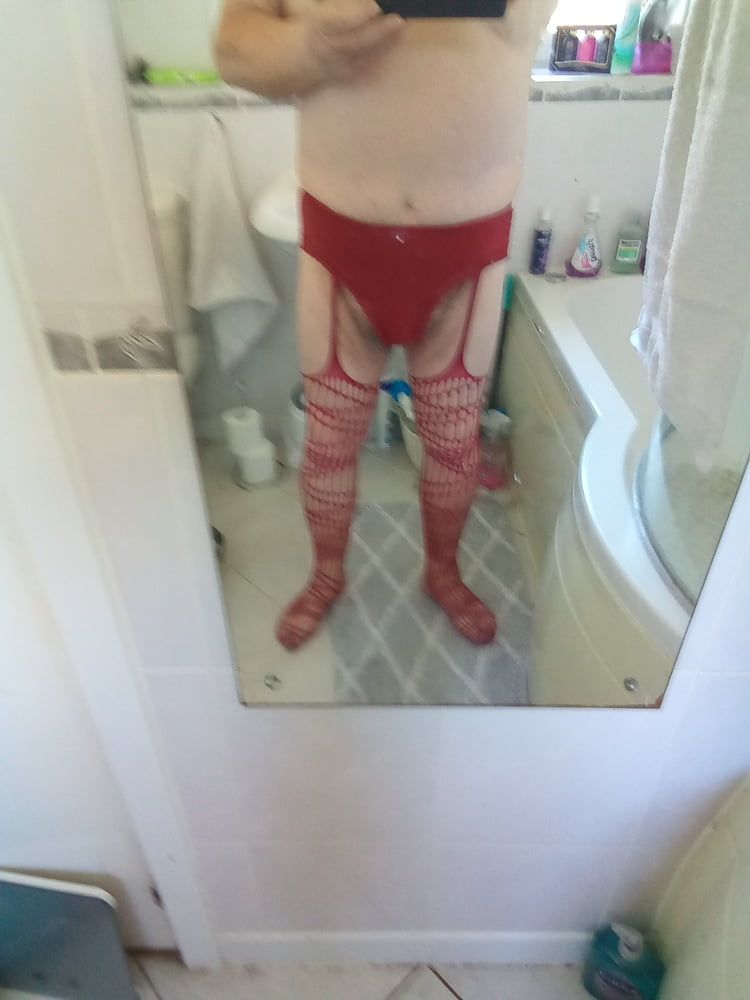 In red fishnets and panties