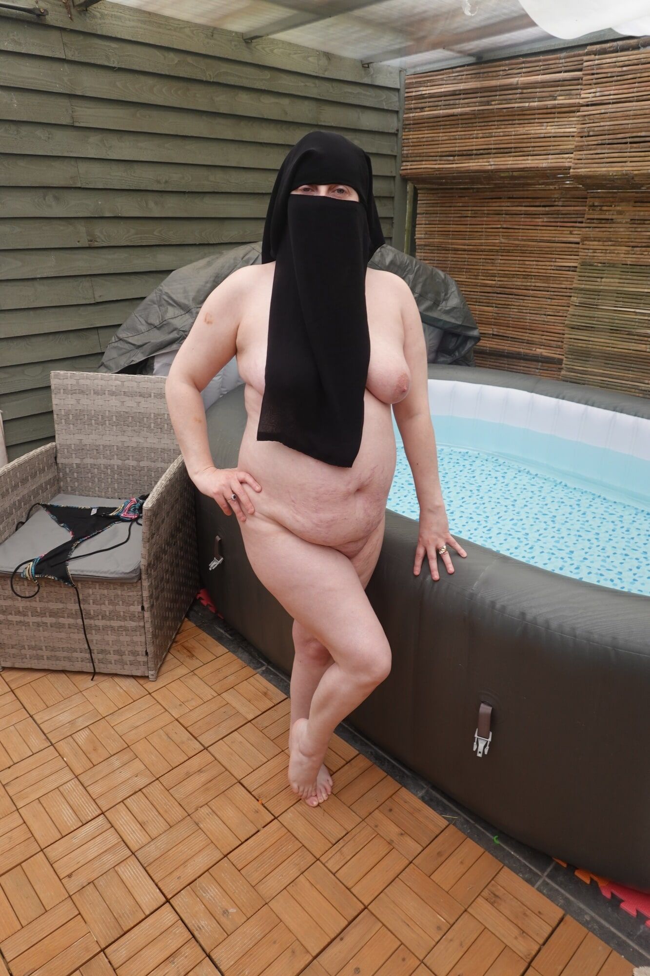 wife showing off big breasts and ass in Niqab