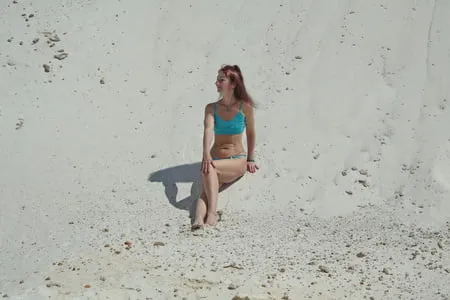 on white sand in turquos bikini         