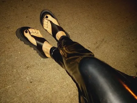 platform flip flops and latex pants         