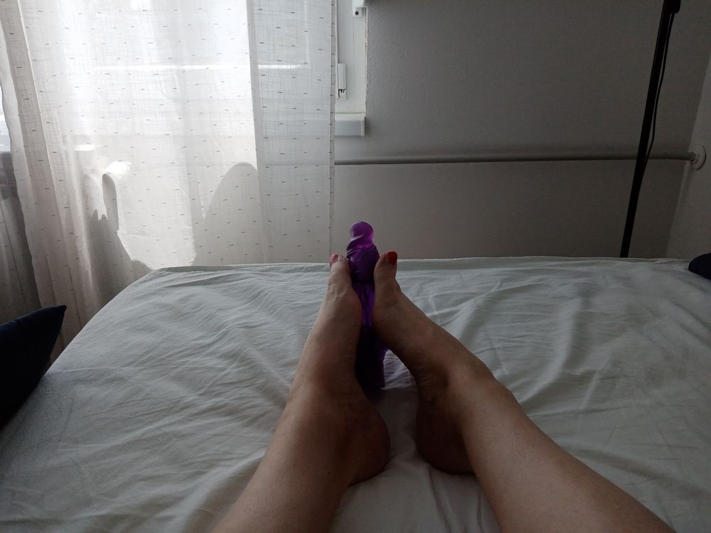 Tranny in a lying position simulates a Footjob with vibrator #3